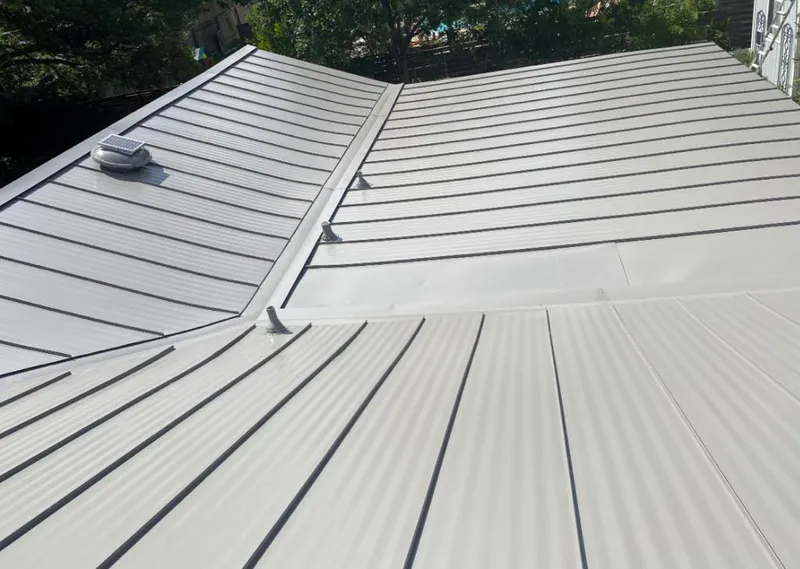 Solar attic fan installed on a metal roof for Roof Ventilation in Middle